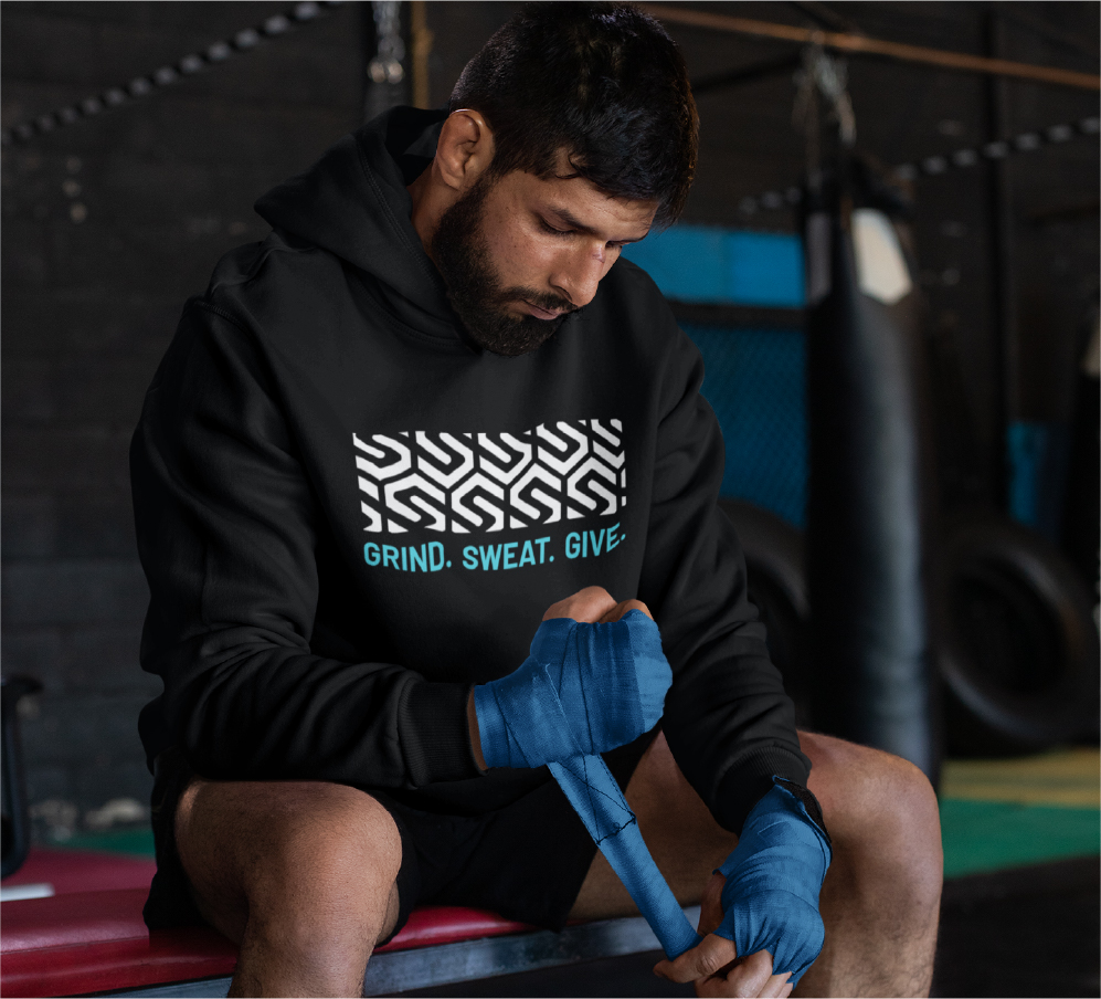 man boxing with grind sweat give hoodie on from saving lives fitness remedy branding