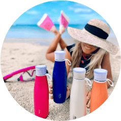 Girl on beach with PURE drinkware speaker bottles