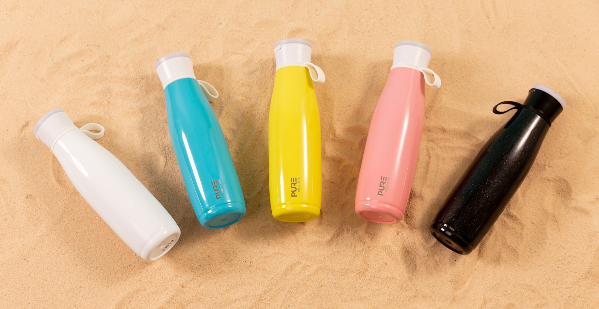 PURE drinkware speaker bottle line up on beach sand by REMEDY brand photography